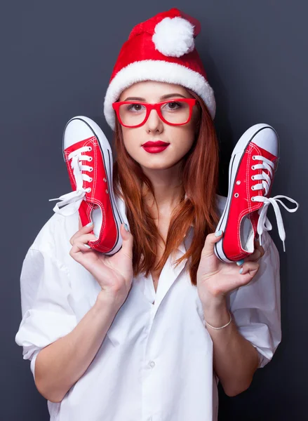 Woman in christmas hat with red gumshoes — Stock Photo, Image