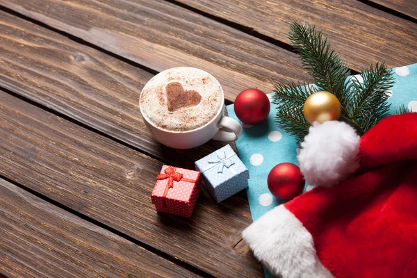 Cup and gift boxes with christmas bubbles — Stock Photo, Image