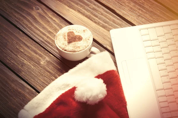 White laptop computer and Santas hat — Stock Photo, Image