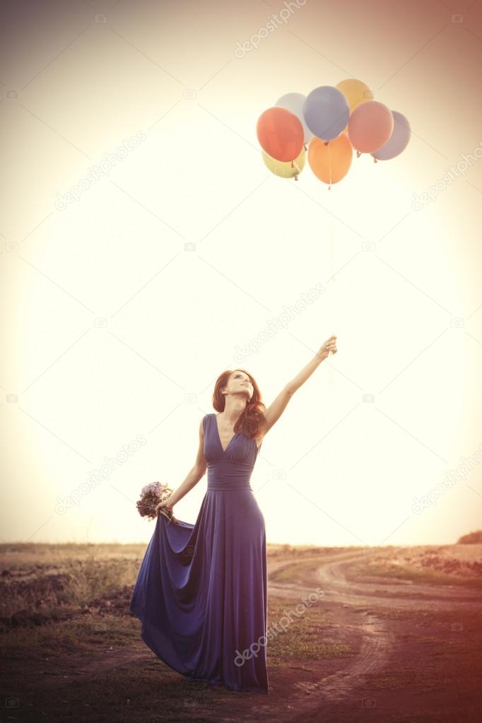 Girl in blue dress with balloons