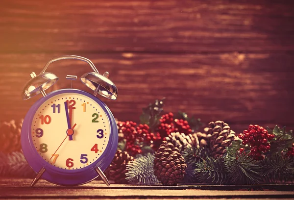 Alarm clock near Pine branches — Stock Photo, Image