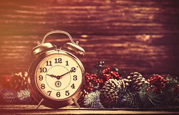 Alarm clock near Pine branches — Stock Photo, Image