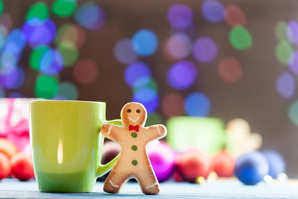 Cup of tea and cookie with Christmas lights — Stock Photo, Image