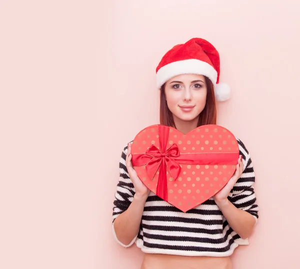 Woman in Santa Claus hat with gift box — Stock Photo, Image