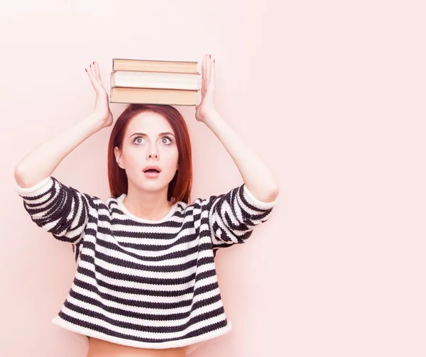 Woman with books above head — Stock Photo, Image