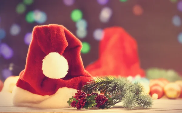 Santas hat and pine branch — Stock Photo, Image