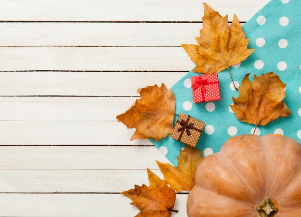 Pumpkin and  leaves  with gifts — Stock Photo, Image