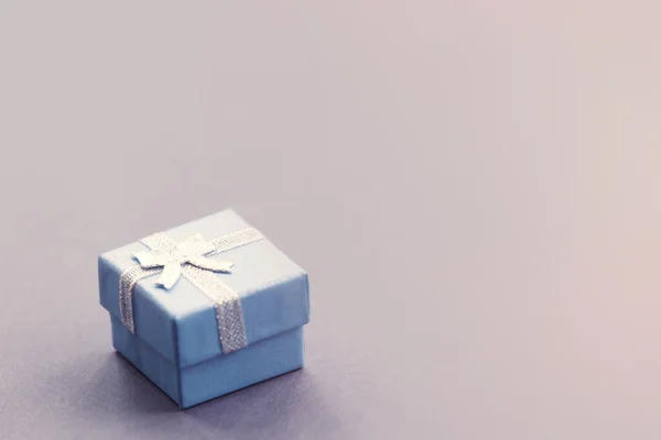 Pequena caixa de presente em cinza — Fotografia de Stock