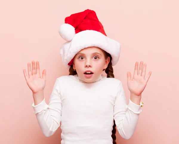 Girl with pigtails in Santa Claus hat — Stock Photo, Image