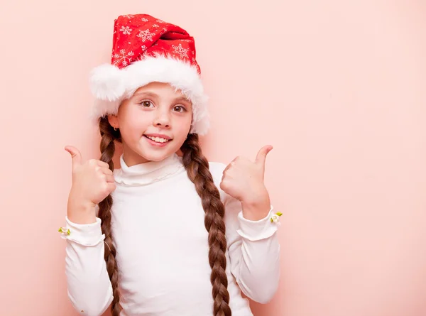 Girl with pigtails in Santa Claus hat — Stock Photo, Image