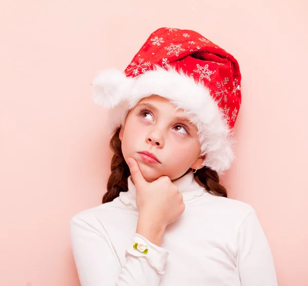 Dívka s copánky v Santa Claus — Stock fotografie