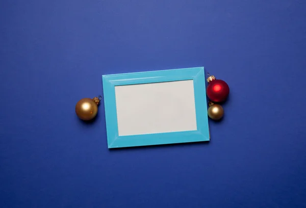 Photo frame and christmas baubles — Stock Photo, Image