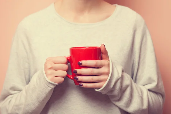 Woman holding cup — Stock Photo, Image