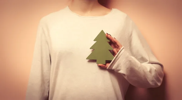 Woman holding a christmas tree shape toy — Stock Photo, Image