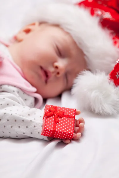 Little baby sleeping with christmas gift — Stock Photo, Image