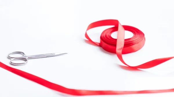 Little scissors and red ribbon — Stock Photo, Image