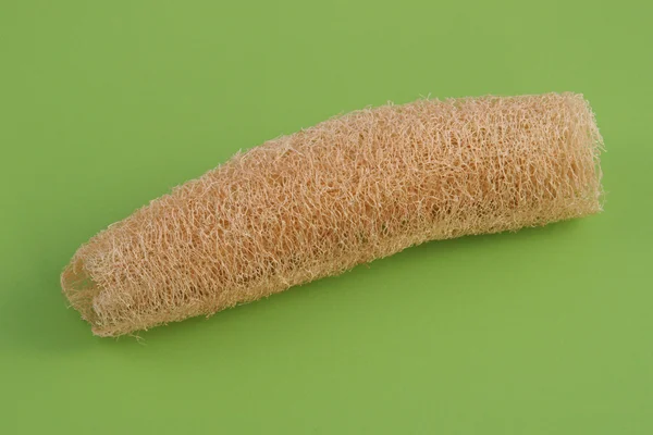 Luffa, loofa utilisé dans les soins de la peau sur fond vert — Photo