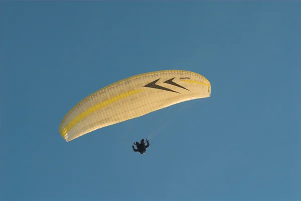 person flying on parachute