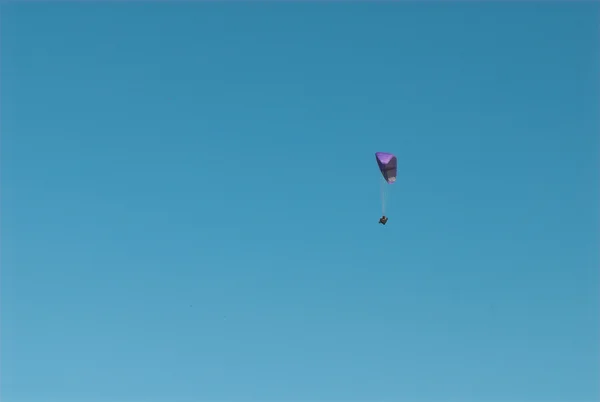 person flying on parachute