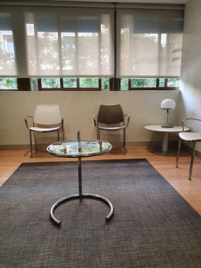 Sessiz boş bekleme odası, sandalyeli ve masalı.