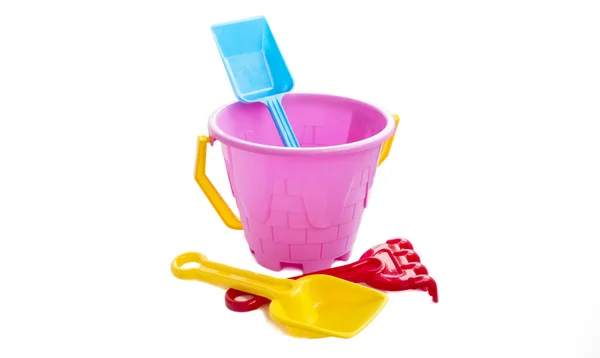 Toy plastic bucket with a shovel and a rake — Stock Photo, Image