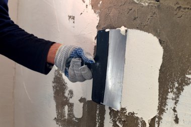 Beyaz bir macun gri beton duvara başvuru süreci 