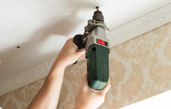 The process of drilling with an electric drill — Stock Photo, Image