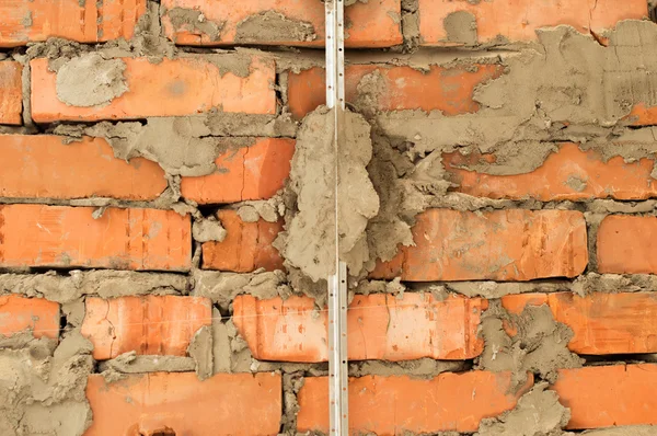 Installation of metal lighthouses on a brick wall