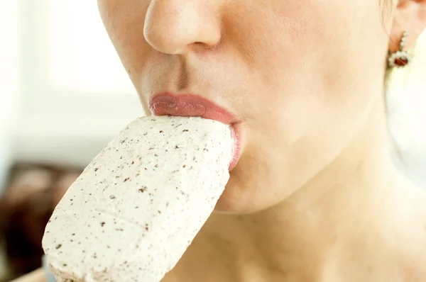 Woman eating white ice cream