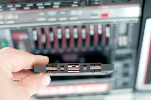 Plastic cassette audio tape in a man\'s hand