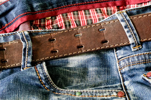 Textile: blue jeans with a brown leather — Stock Photo, Image