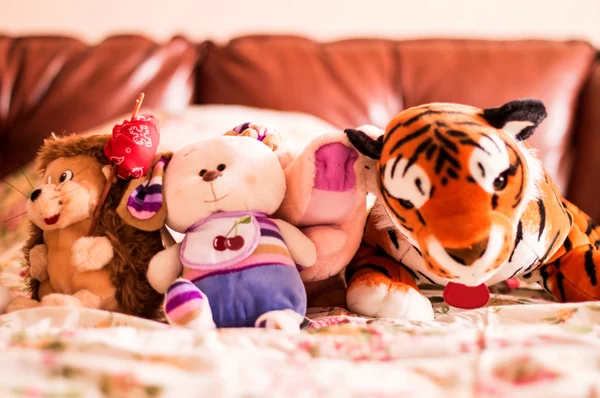 Different soft toys for children on the couch — Stock Photo, Image