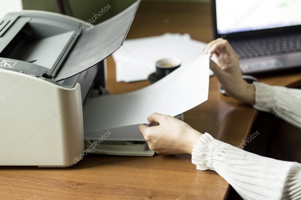 The process of inserting paper in laser printer cartridge Stock Photo