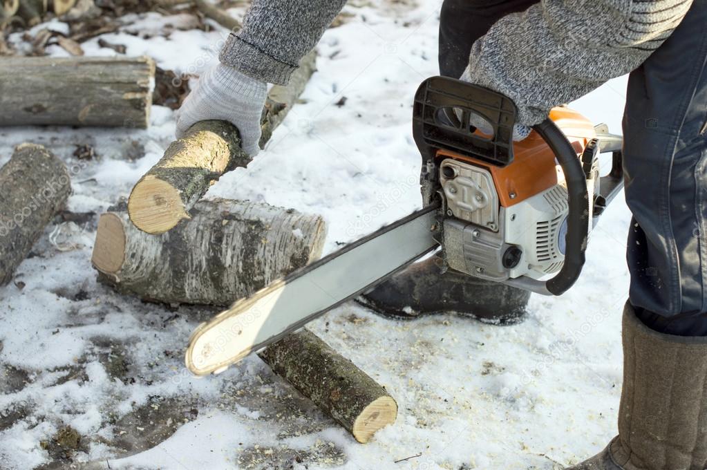 The process of cutting firewood with chainsaw 