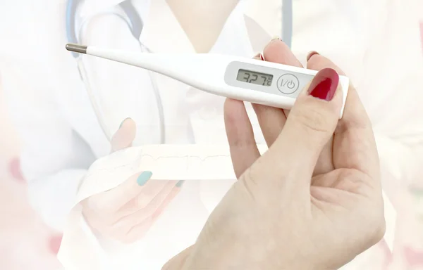 Electronic thermometer in hand — Stock Photo, Image