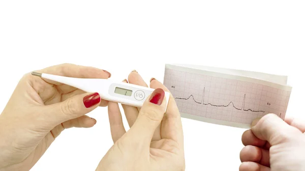 Cardiogram and an electronic thermometer in women's hands — Stock Photo, Image