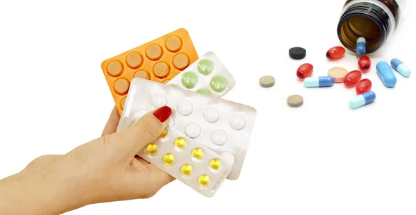 Verschillende tabletten in handen en op een witte achtergrond — Stockfoto