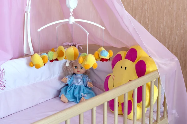 Various soft toys in the cot with orange linen — Stock Photo, Image