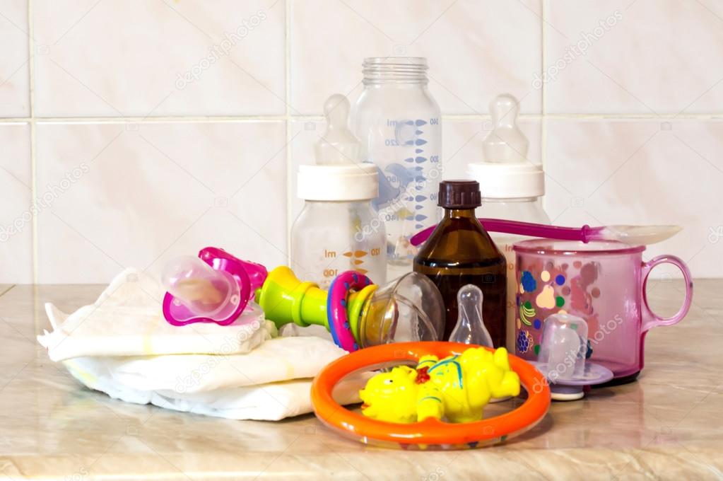 Glass bottle with the mixture for feeding, toys and baby diapers