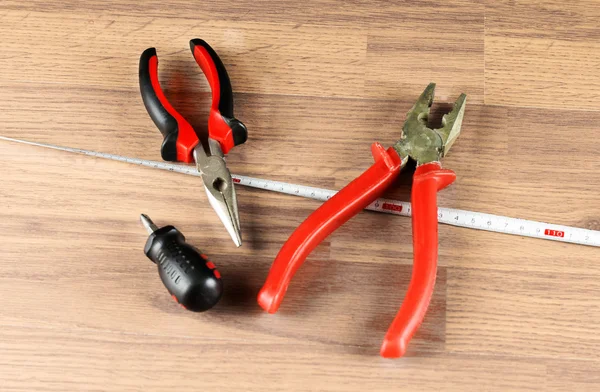 Pliers, screwdriver and measuring tape — Stock Photo, Image
