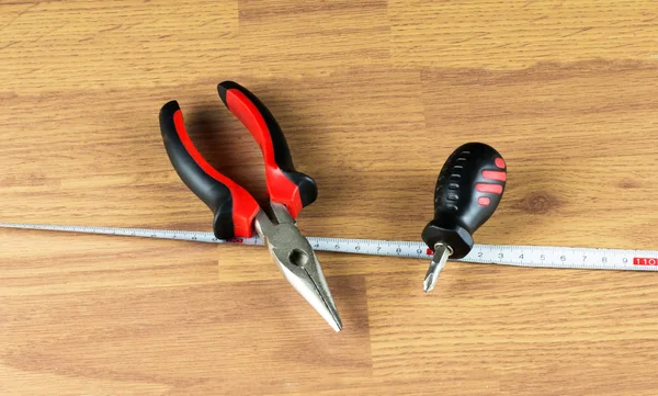Pliers, screwdriver and measuring tape — Stock Photo, Image