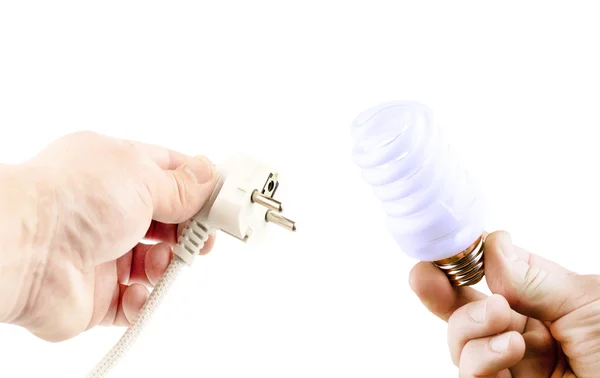 Флуоресцентная лампа и Штепсель в разных руках — стоковое фото