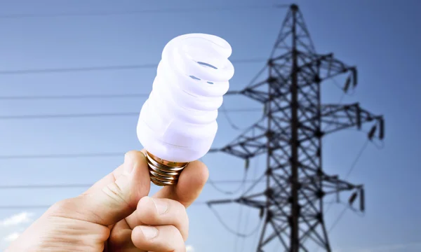 Fluorescent light bulb in his hand — Stock Photo, Image