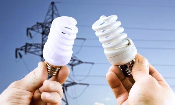 Fluorescent light bulbs in hands — Stock Photo, Image