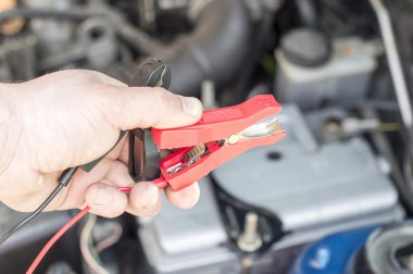 The process of connecting the charger to the the vehicle battery clipart