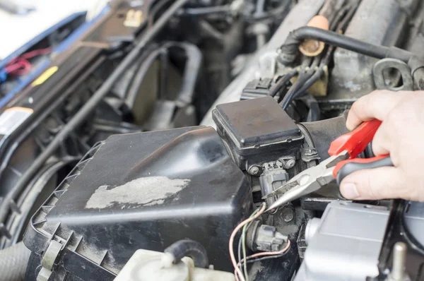 The process of repairing vehicle using pliers — Stock Photo, Image