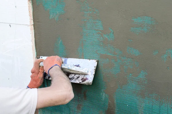 Applying putty to the  wall using a spatula — Stock Photo, Image