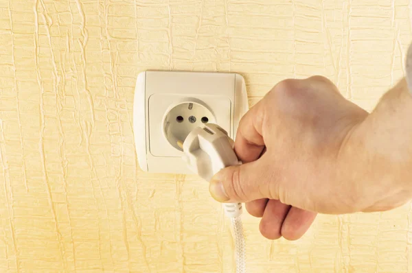 The process of connecting the white plug into the socket — Stock Photo, Image