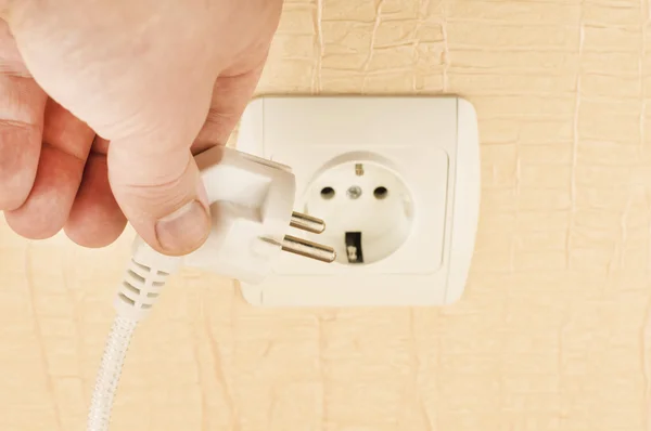 The process of connecting the white plug into the socket — Stock Photo, Image