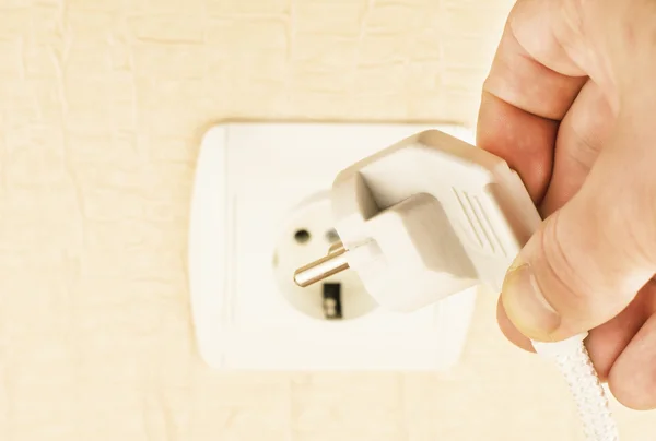 The process of connecting the white plug into the socket — Stock Photo, Image
